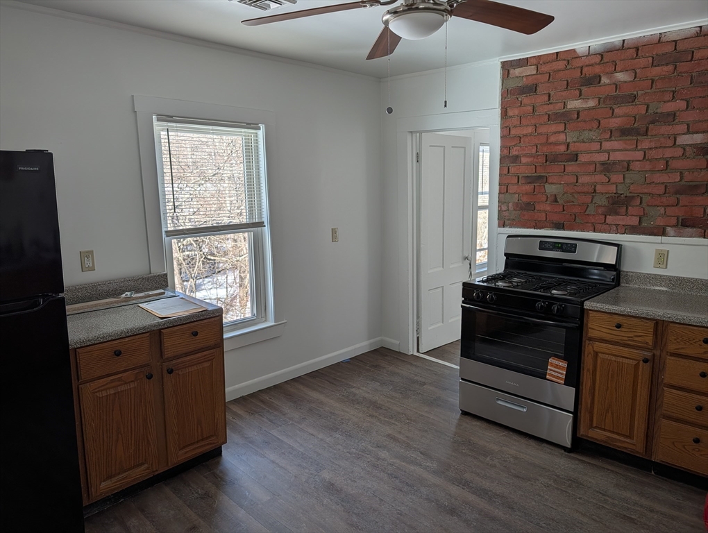9 Turnpike Road, Unit 2 Montague, MA 01376 - Photo 3 of 21 a kitchen with a stove and wooden floor