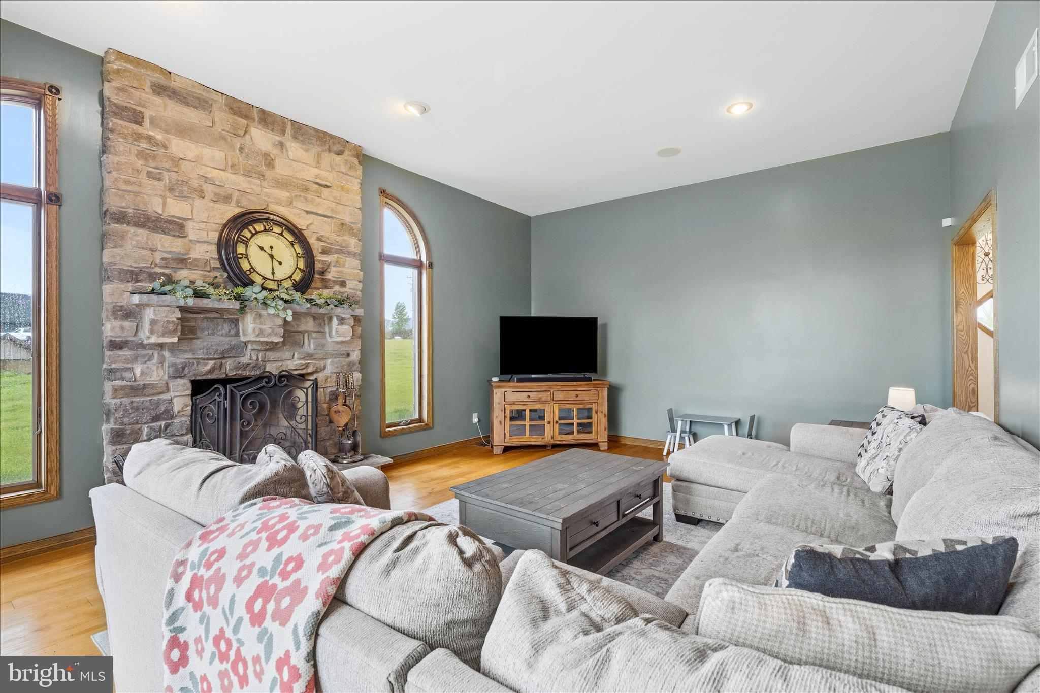11820 Shimpstown Road Mercersburg, PA 17236 - Photo 11 of 75 a living room with furniture a fireplace and a flat screen tv