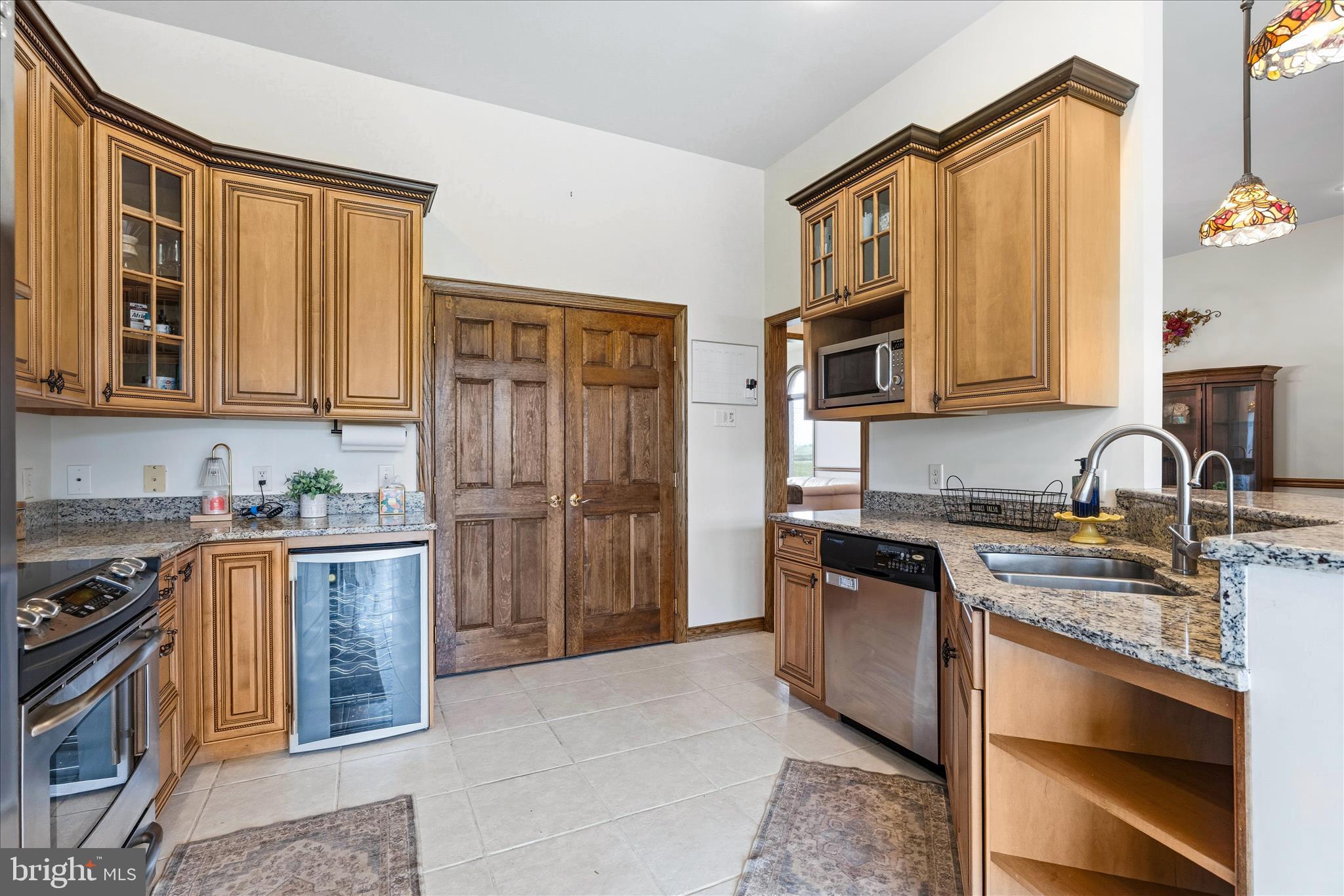 11820 Shimpstown Road Mercersburg, PA 17236 - Photo 16 of 75 a kitchen with stainless steel appliances granite countertop a stove a sink dishwasher and a refrigerator