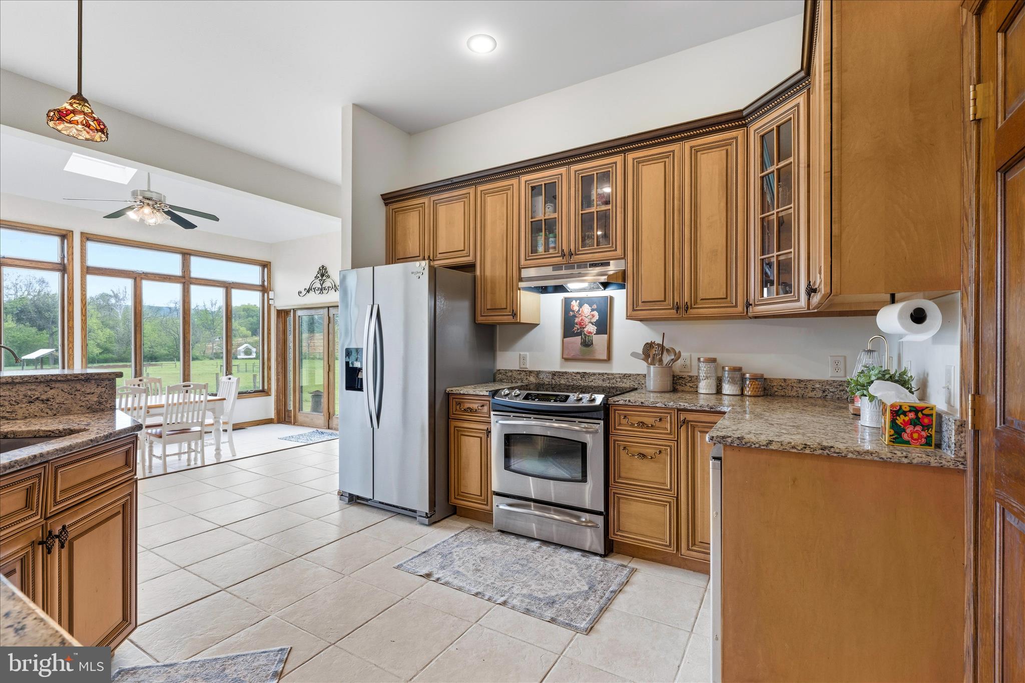 11820 Shimpstown Road Mercersburg, PA 17236 - Photo 18 of 75 a kitchen with stainless steel appliances granite countertop a refrigerator a stove and a sink with cabinets