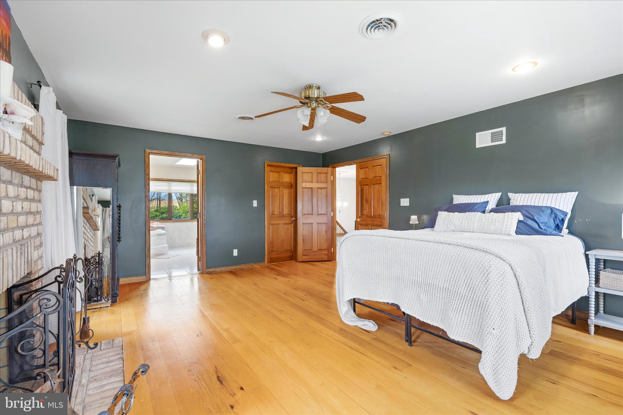 11820 Shimpstown Road Mercersburg, PA 17236 - Photo 33 of 75 a spacious bedroom with a bed and a chandelier
