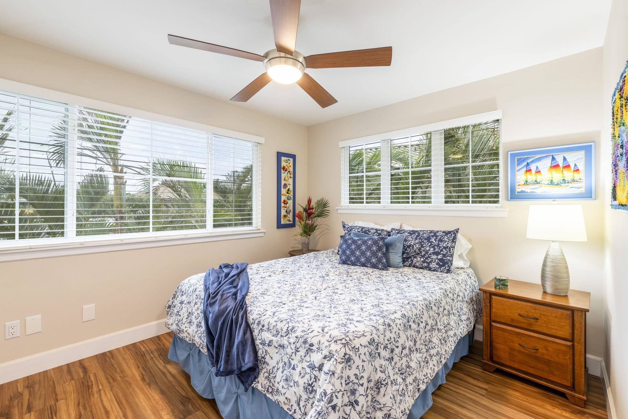 16 Kai Makani Loop, Unit D201 Kihei, HI 96753 - Photo 24 of 50 a bedroom with a large bed and a window