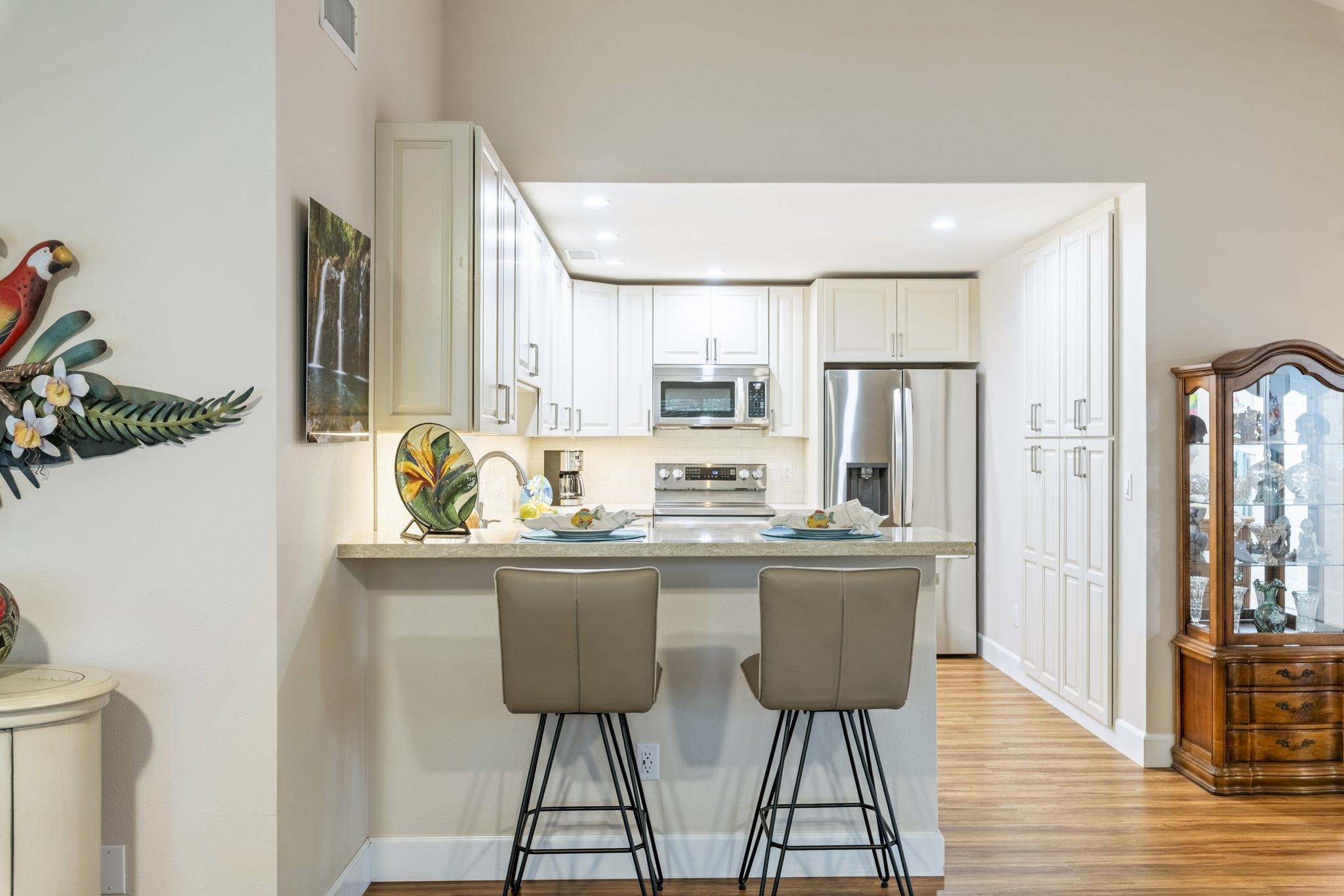 16 Kai Makani Loop, Unit D201 Kihei, HI 96753 - Photo 6 of 50 a dining table seating space with wooden floor and furniture