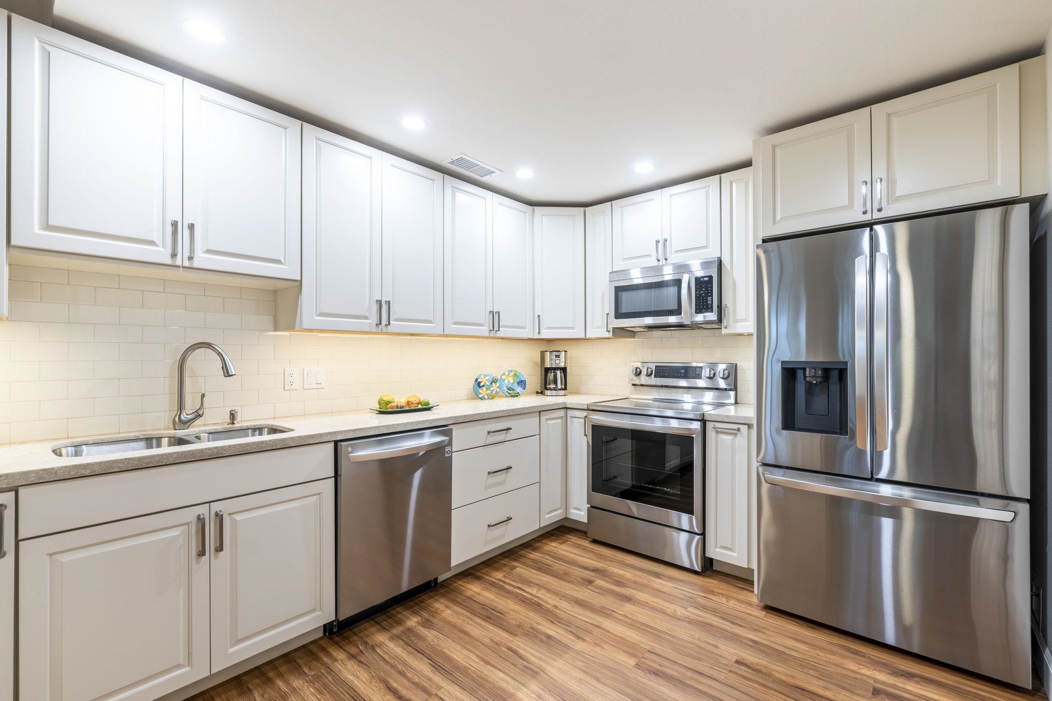 16 Kai Makani Loop, Unit D201 Kihei, HI 96753 - Photo 8 of 50 a kitchen with stainless steel appliances granite countertop a refrigerator sink and cabinets