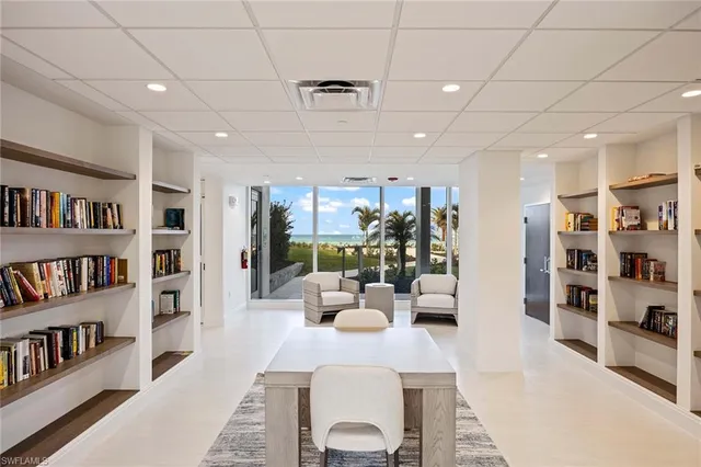 a living room with furniture and a book shelf