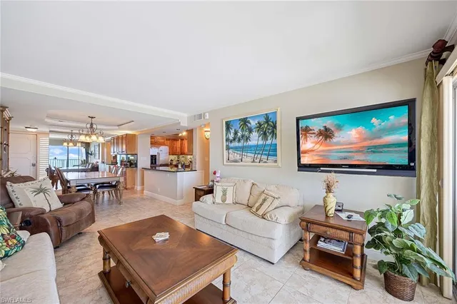 a living room with furniture a rug and a flat screen tv