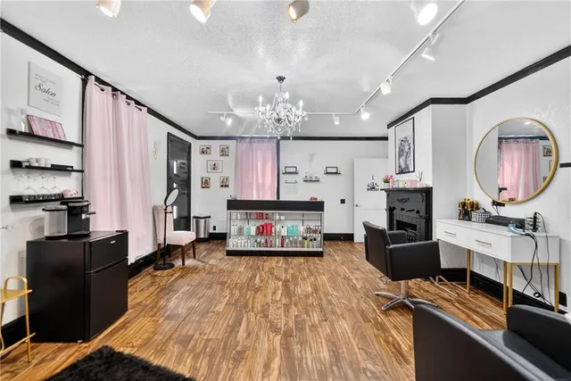 a living room with furniture and a chandelier