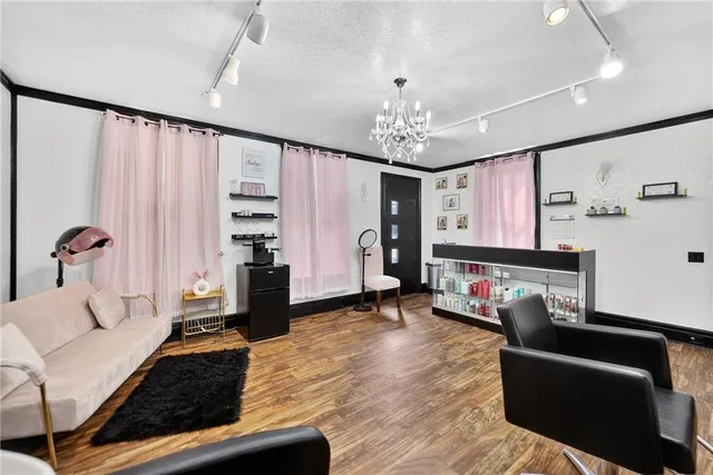 a living room with furniture and a chandelier