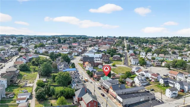 an aerial view of a houses with a swimming pool