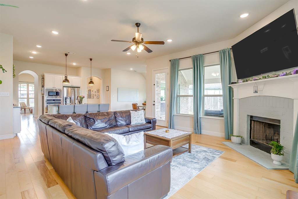 416 Bluffside Trail Benbrook, TX 76126 - Photo 11 of 40 a living room with furniture a fireplace and a flat screen tv