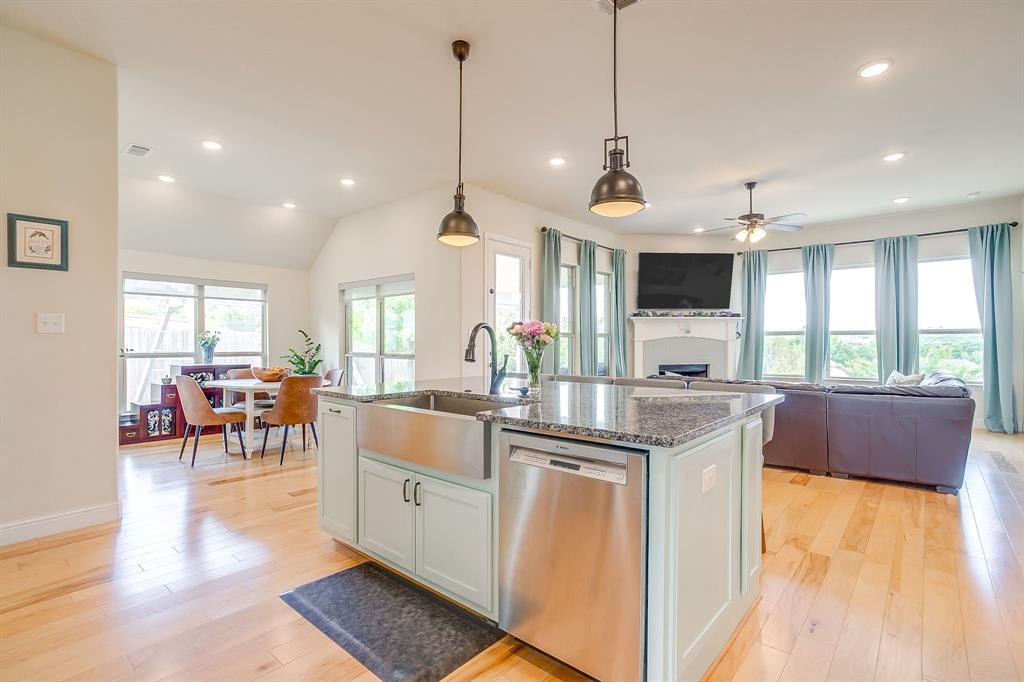 416 Bluffside Trail Benbrook, TX 76126 - Photo 12 of 40 a open kitchen with stainless steel appliances granite countertop a stove and a wooden floors