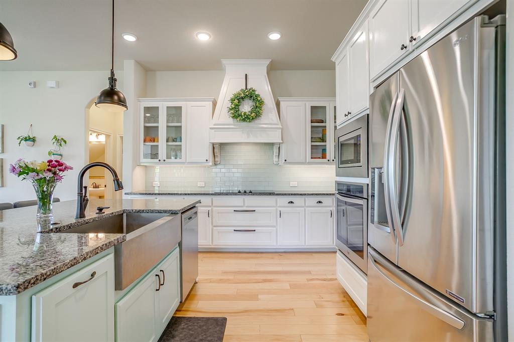 416 Bluffside Trail Benbrook, TX 76126 - Photo 15 of 40 a kitchen with stainless steel appliances granite countertop a refrigerator and a sink