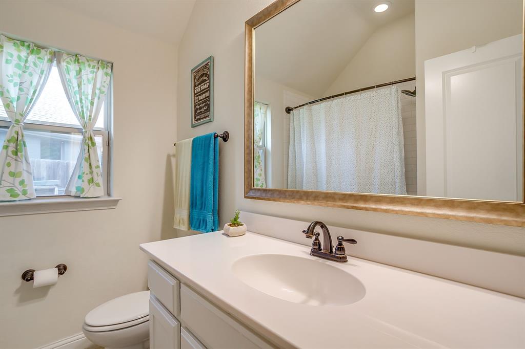 416 Bluffside Trail Benbrook, TX 76126 - Photo 27 of 40 a bathroom with a sink a toilet and tub