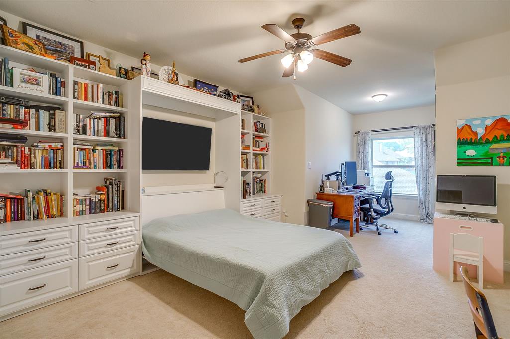 416 Bluffside Trail Benbrook, TX 76126 - Photo 31 of 40 a bedroom with a bed a flat screen tv and a book shelf