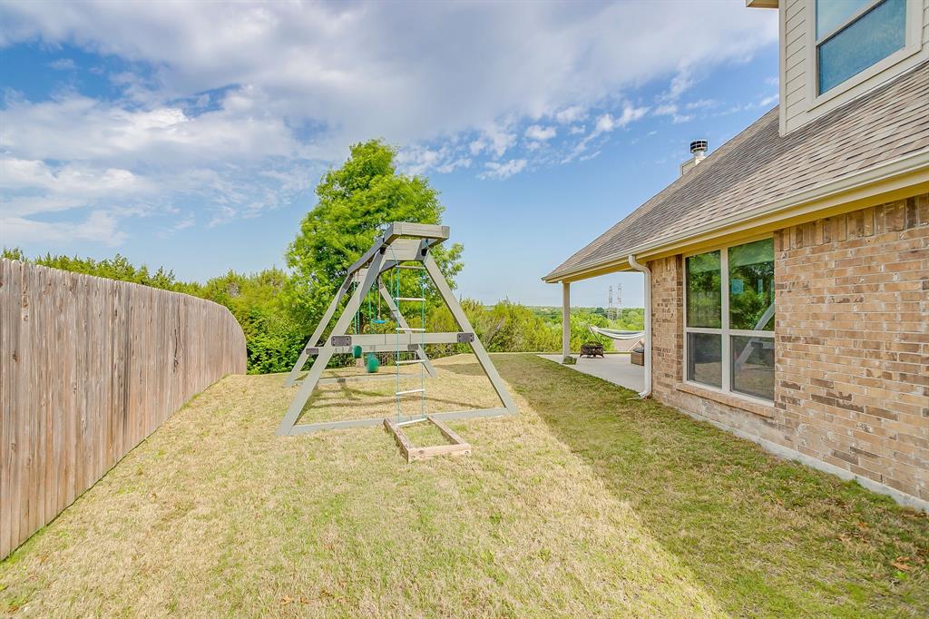 416 Bluffside Trail Benbrook, TX 76126 - Photo 39 of 40 a view of an house with backyard and a garden