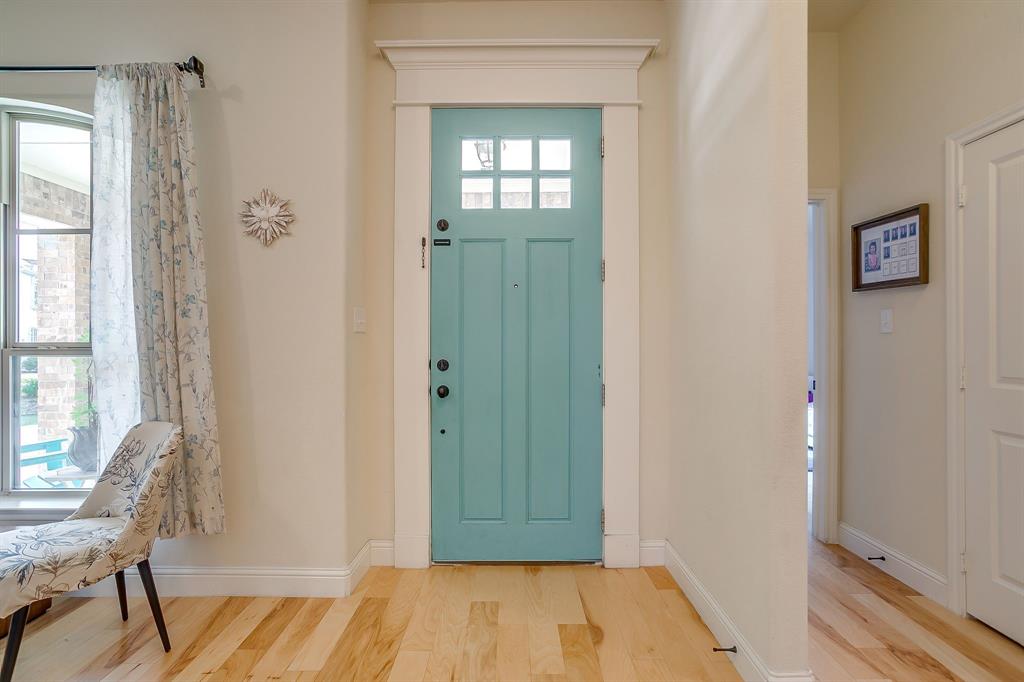 416 Bluffside Trail Benbrook, TX 76126 - Photo 5 of 40 a view of a hallway with wooden floor and a livingroom