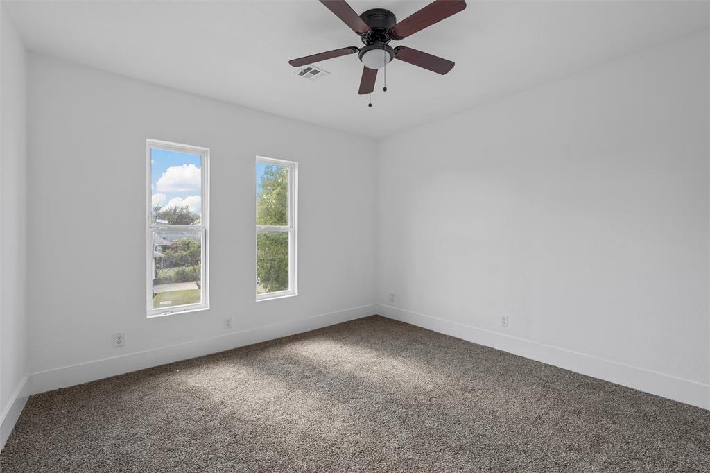 1825 Lyle Avenue Waco, TX 76708 - Photo 17 of 26 an empty room with windows and fan