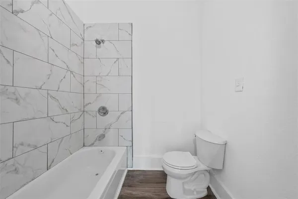 a bathroom with a toilet and bathtub
