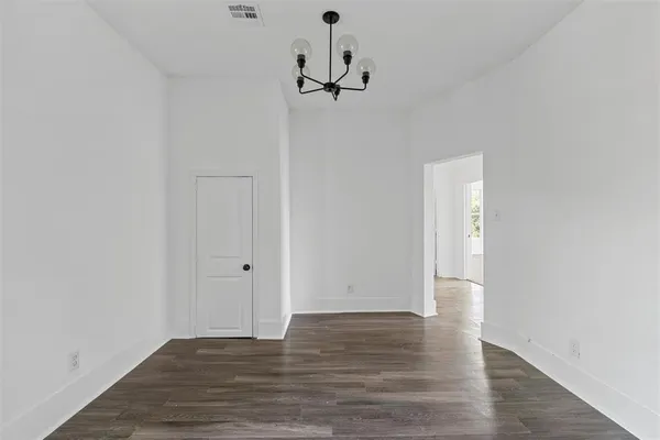 a view of a room with wooden floor and white walls