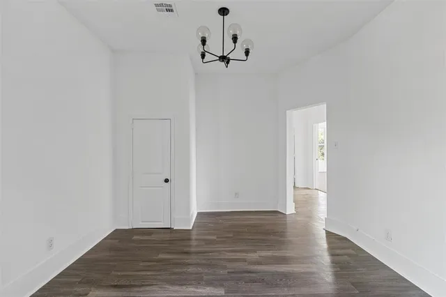 a view of a room with wooden floor and white walls