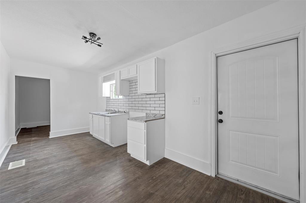 1825 Lyle Avenue Waco, TX 76708 - Photo 7 of 26 a kitchen with a refrigerator and white cabinets