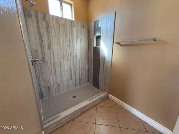 a bathroom with a shower and a sink