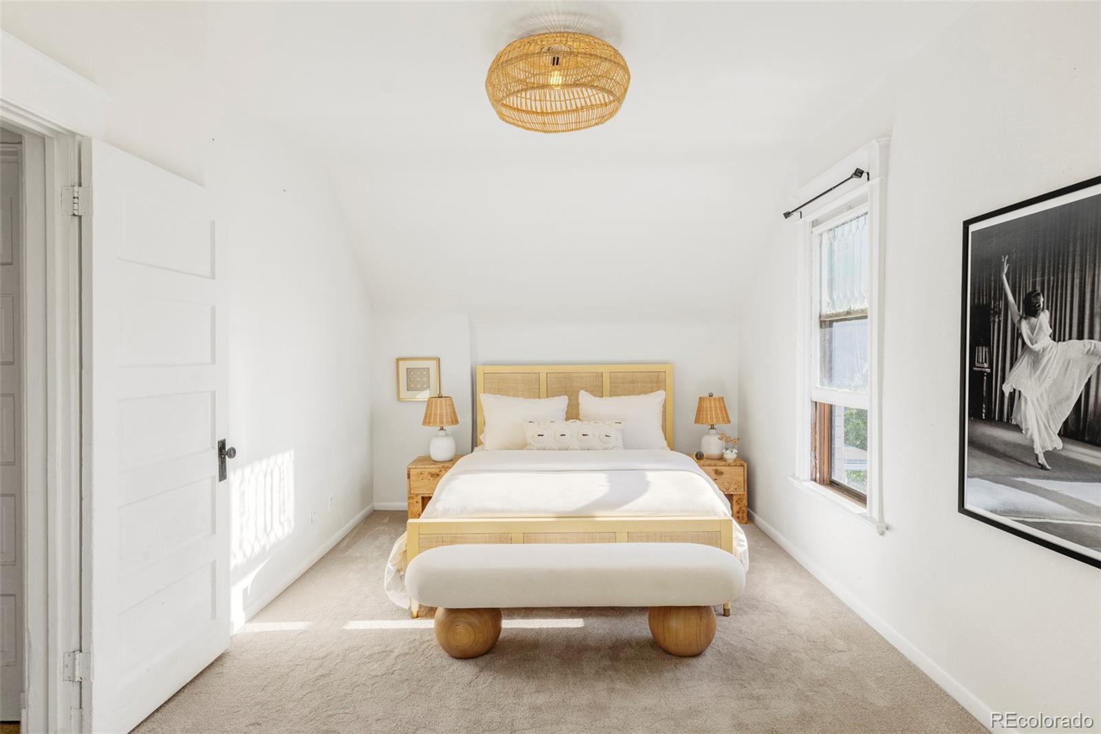 142 Logan Street Denver, CO 80203 - Photo 14 of 32 a bedroom with a bed and a painting on the wall