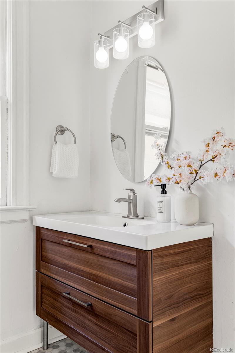 142 Logan Street Denver, CO 80203 - Photo 16 of 32 a bathroom with a sink and a mirror