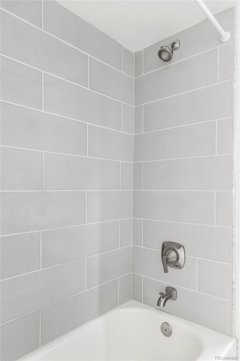 142 Logan Street Denver, CO 80203 - Photo 17 of 32 a bathroom with a shower and a bathtub