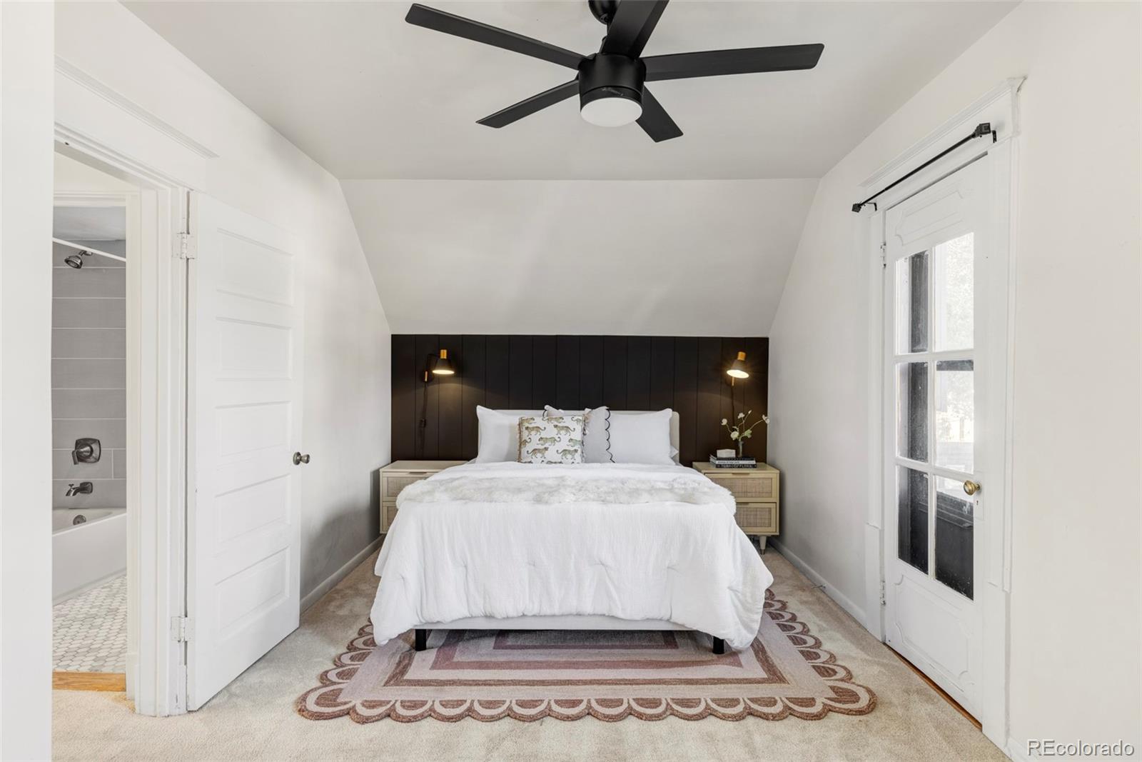 142 Logan Street Denver, CO 80203 - Photo 18 of 32 a spacious bedroom with a bed and a window