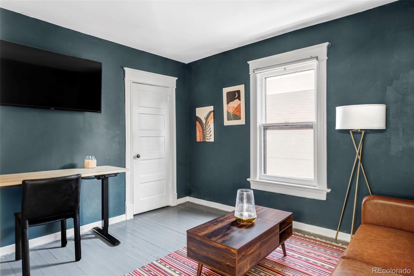 142 Logan Street Denver, CO 80203 - Photo 20 of 32 a living room with furniture and a window