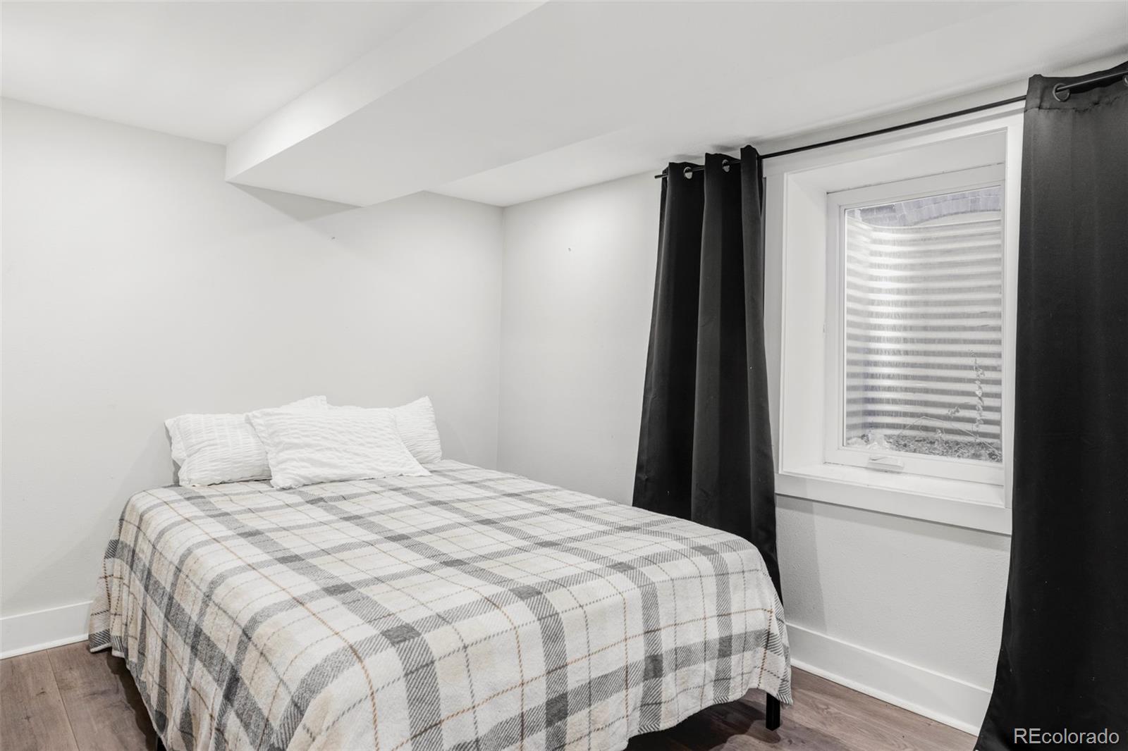 142 Logan Street Denver, CO 80203 - Photo 22 of 32 a bedroom with a bed and a window