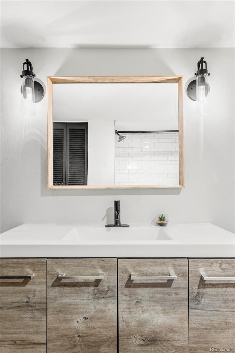 142 Logan Street Denver, CO 80203 - Photo 23 of 32 a bathroom with a sink and a mirror