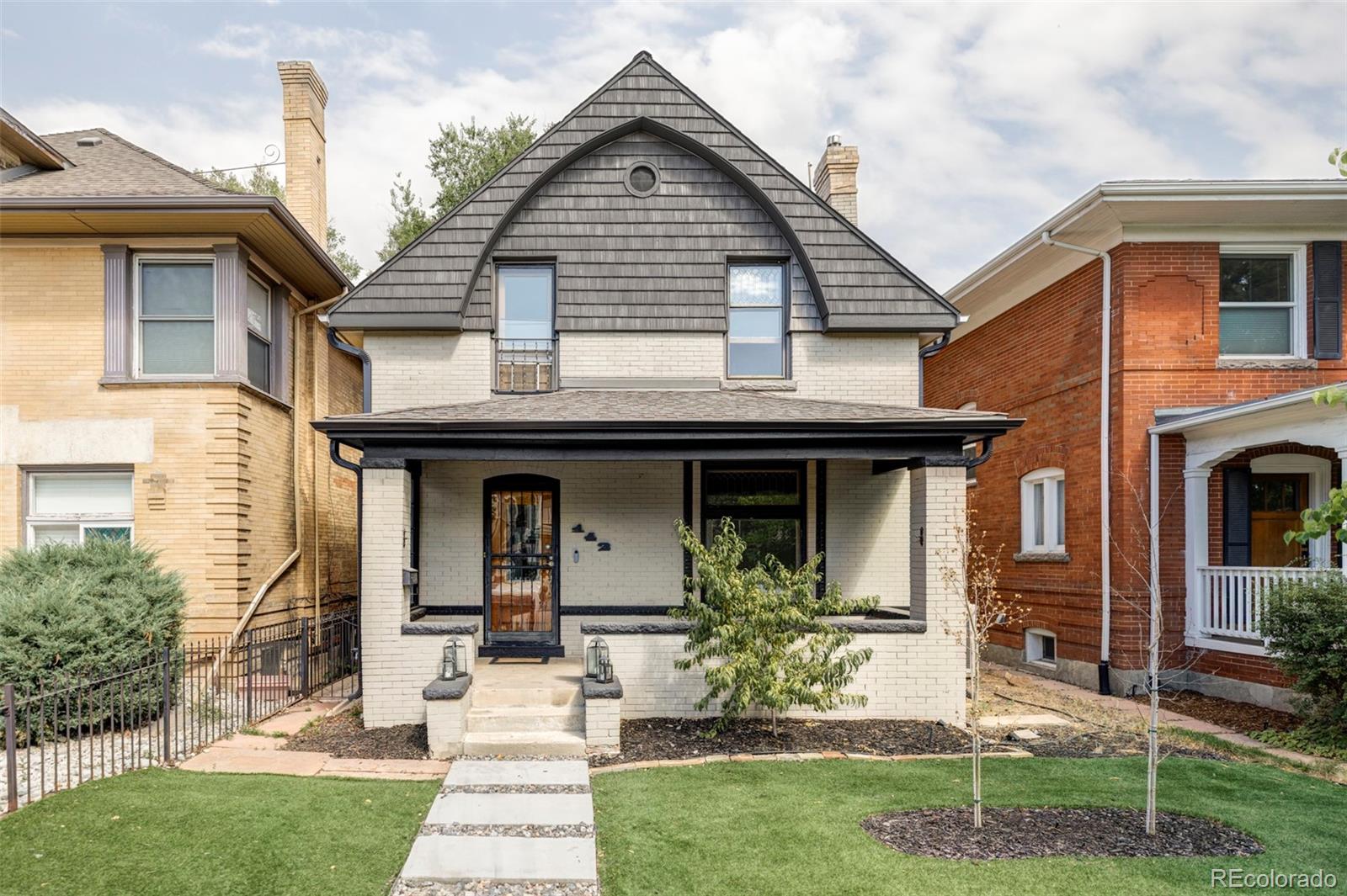 142 Logan Street Denver, CO 80203 - Photo 25 of 32 a front view of a house with garden