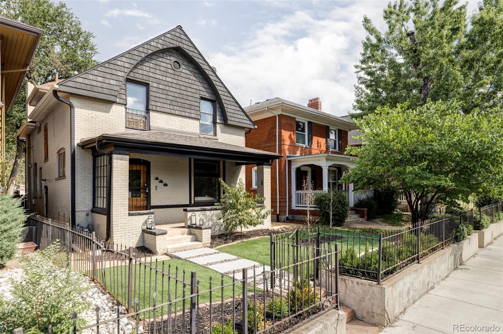 142 Logan Street Denver, CO 80203 - Photo 26 of 32 a front view of a house with garden