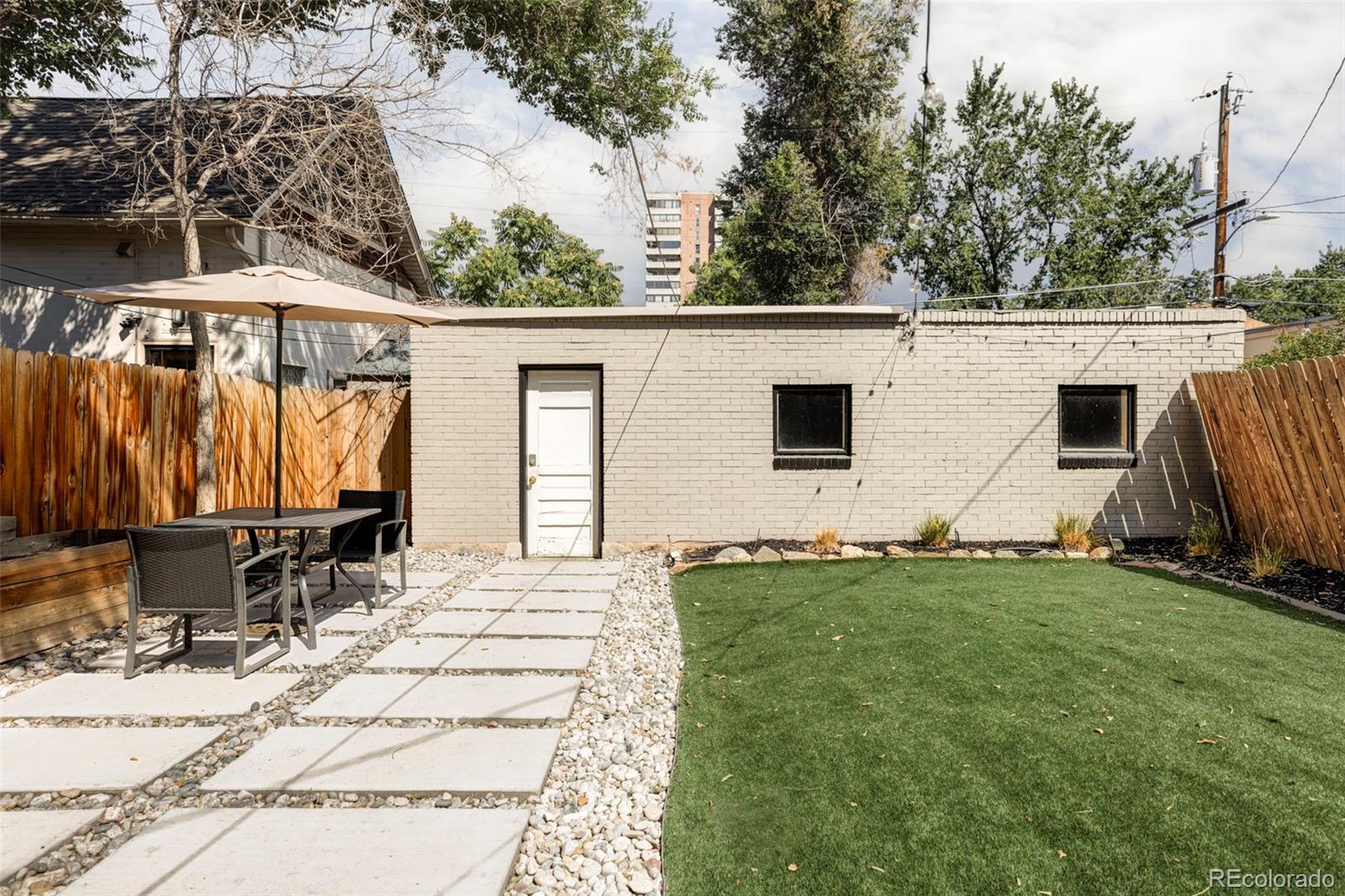 142 Logan Street Denver, CO 80203 - Photo 29 of 32 a view of a backyard with a sitting area
