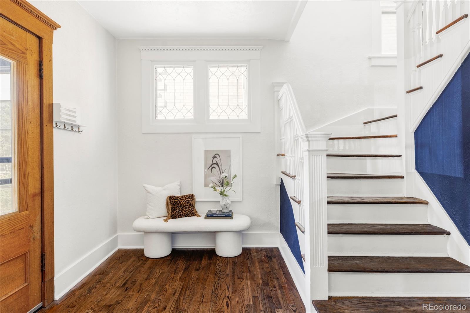142 Logan Street Denver, CO 80203 - Photo 5 of 32 a view of a room that has a couch and a table in it