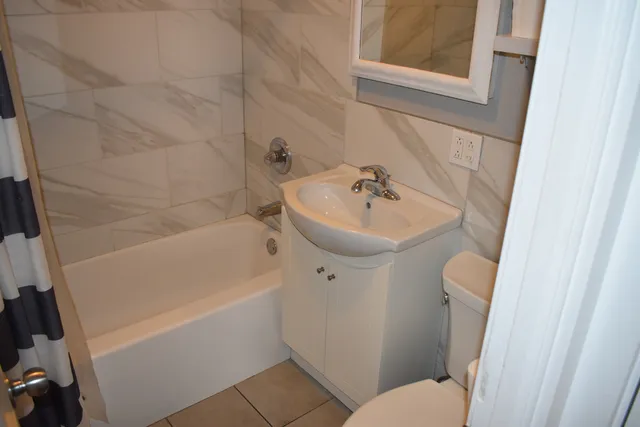 a bathroom with a bathtub and a toilet