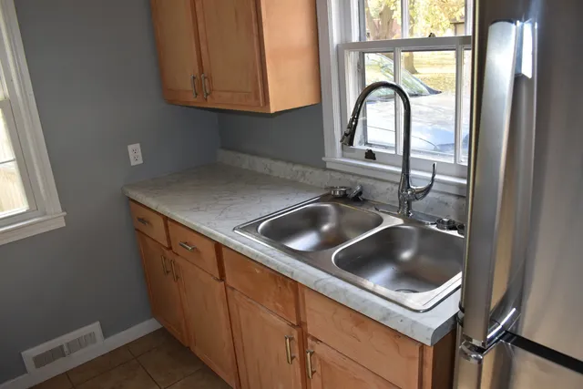 a kitchen with a sink a stove and cabinets