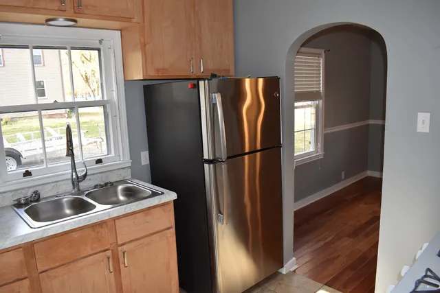 a kitchen with a refrigerator and a sink