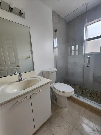 a bathroom with a toilet sink and shower