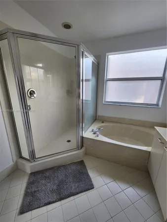 a bathroom with a bathtub and a shower