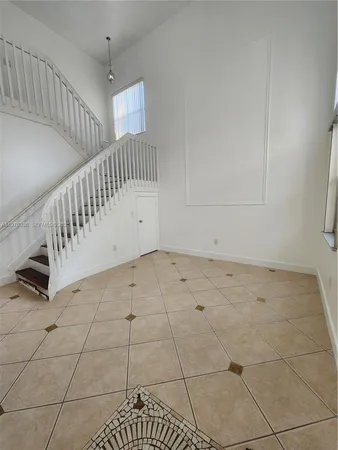 a view of an empty room with stairs