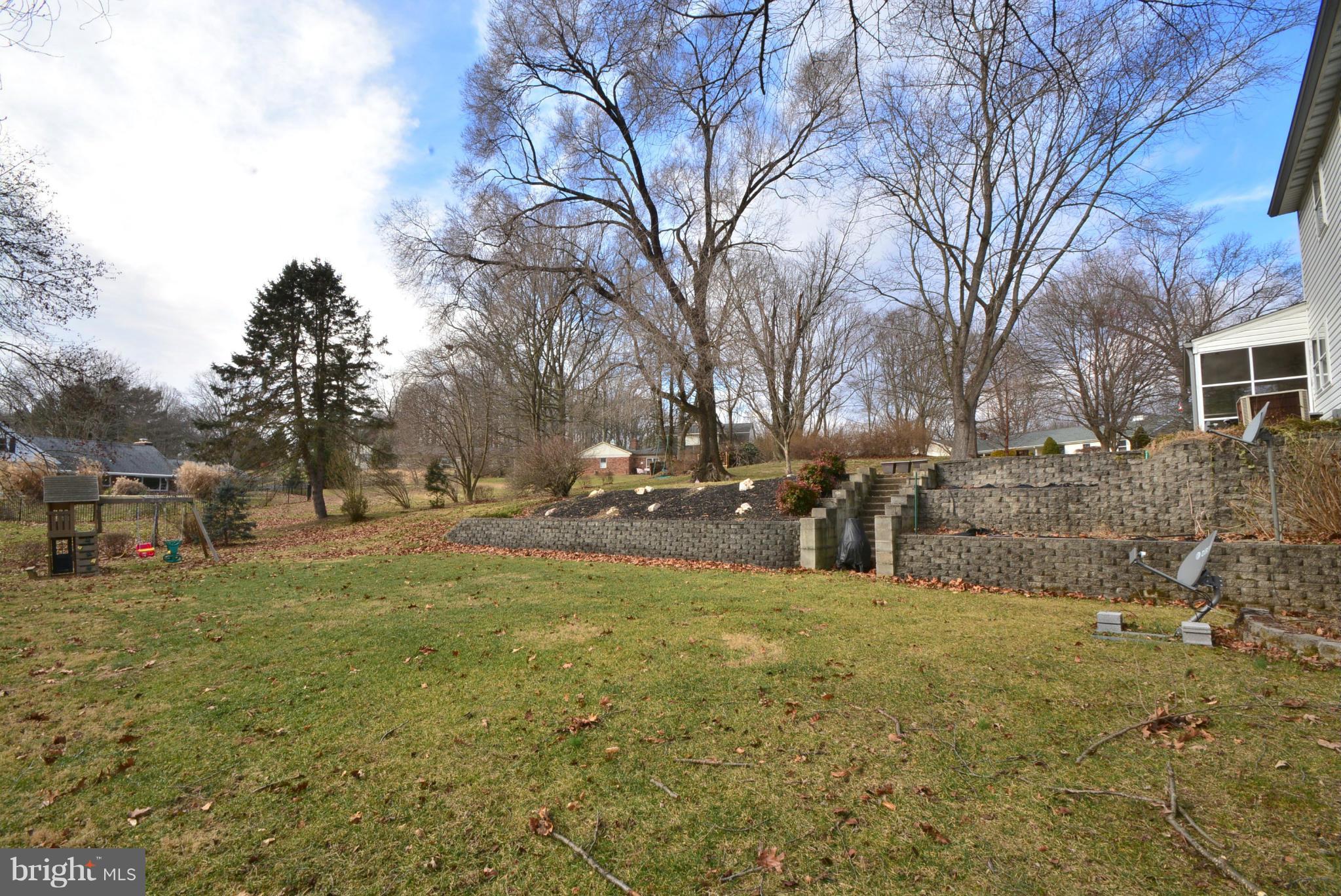 1502 Rolling Road Bel Air, MD 21014 - Photo 29 of 30 Exterior (Rear) with stone retaining wall