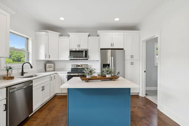 a kitchen with stainless steel appliances a sink and a stove