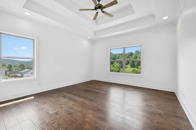 a spacious en suite bathroom with double sink and a mirror
