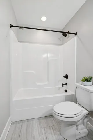 an empty room with a window and a ceiling fan