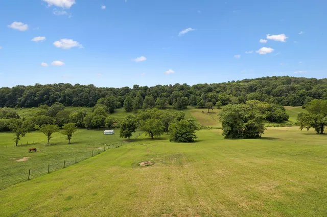 a view of a golf course with a lake and mountain view