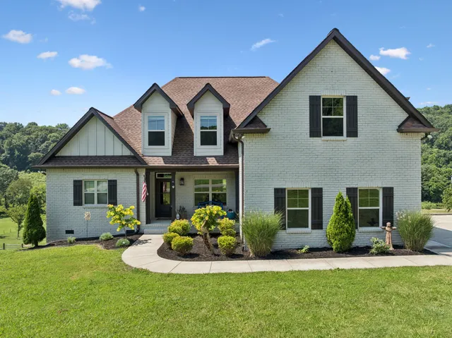 a front view of a house with a yard and garage