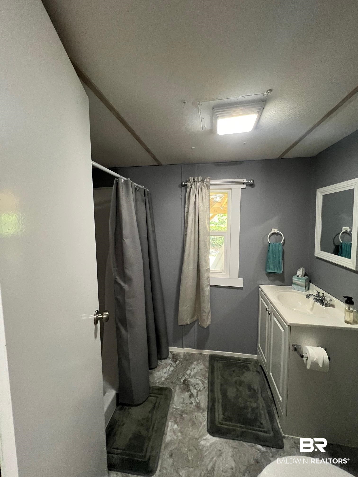 1420 Ridgewood Circle Lillian, AL 36549 - Photo 15 of 41 Bathroom with vanity and curtained shower